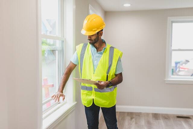 a property inspector checking the windows inside a home